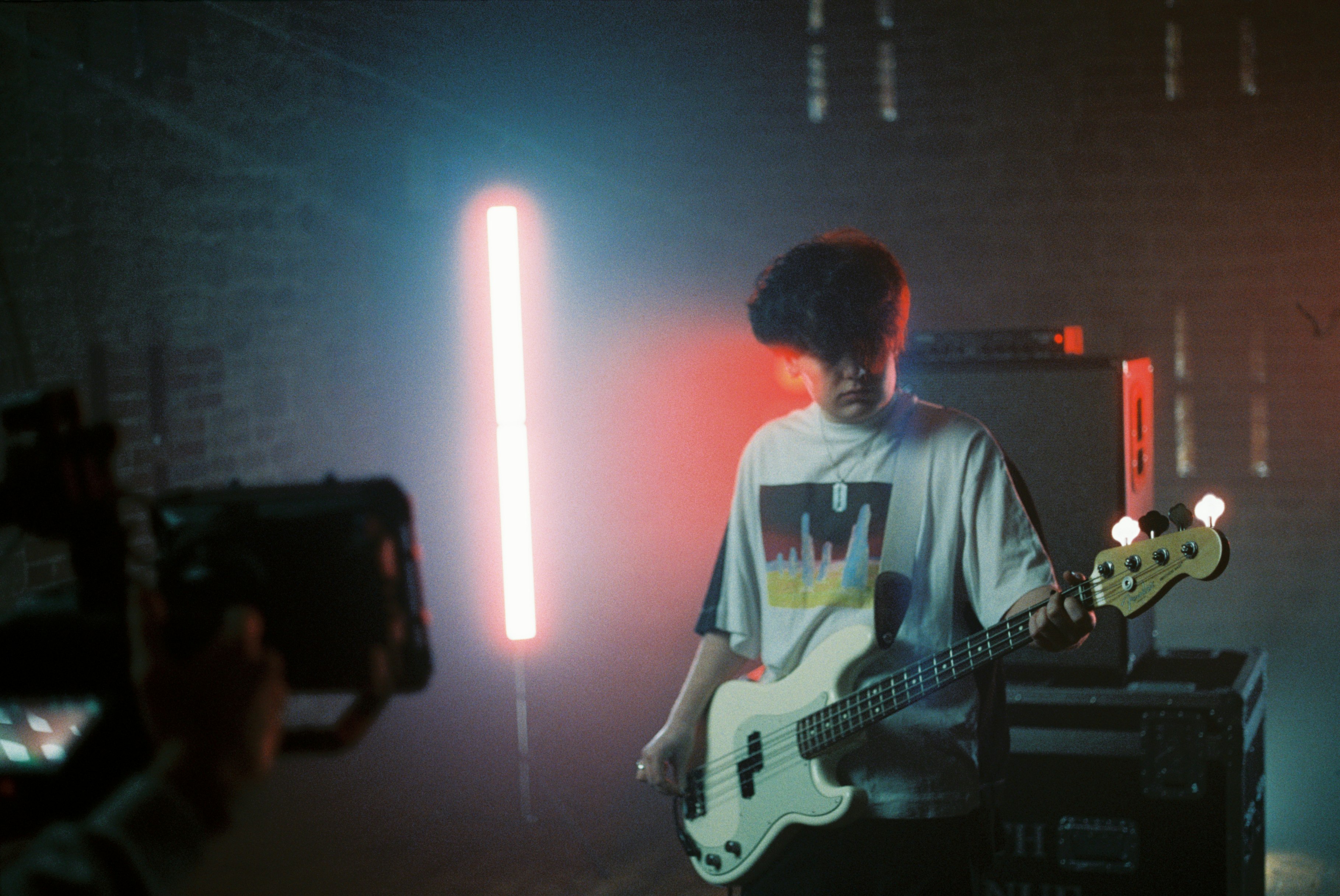 man in white and black crew neck t-shirt playing electric guitar